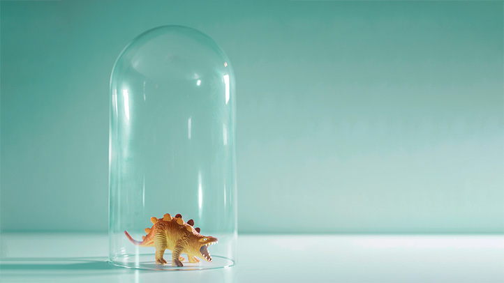 babyproofing the house, glass jar over small toy dinosaur
