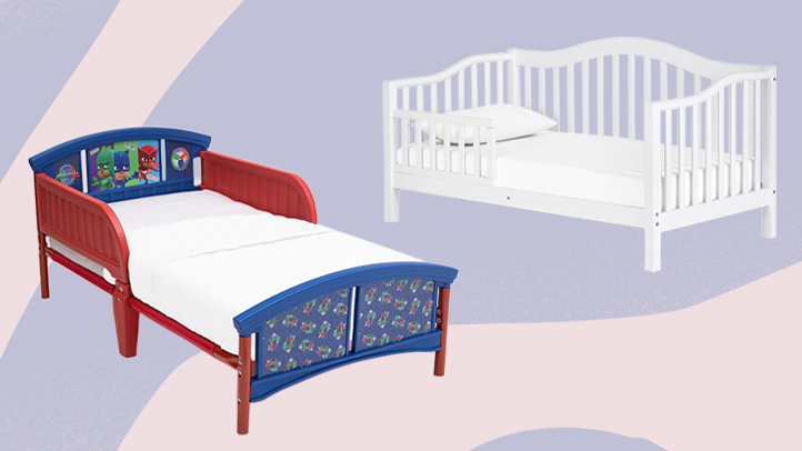 Two toddler beds, one plastic one with PJ Masks stickers and one white classic-looking toddler day bed