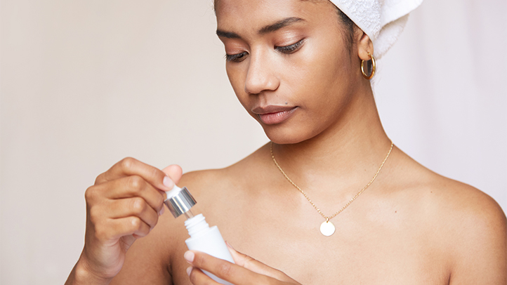 bloodshot eyes postpartum, woman using eye drops