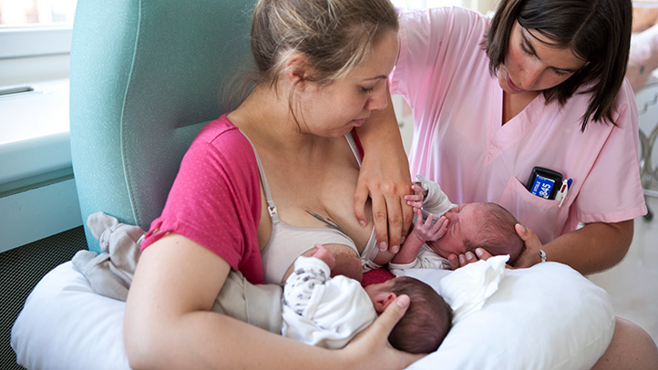mom breastfeeding twins