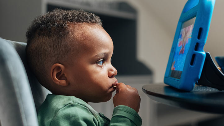 cleaning toddler ears, toddler boy watching tablet