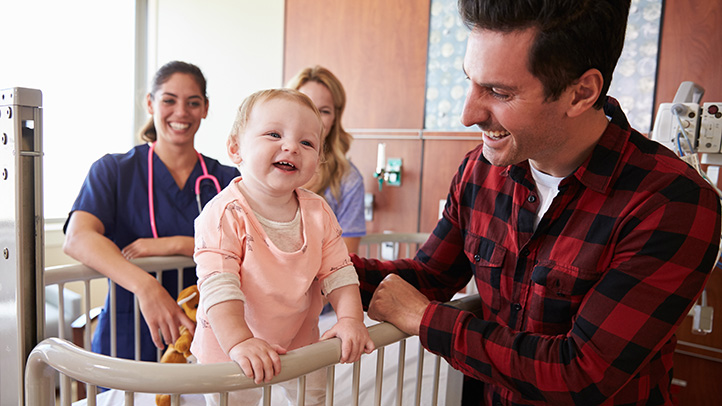 smiling baby with mother and father, baby getting the flu shot or influenza vaccine