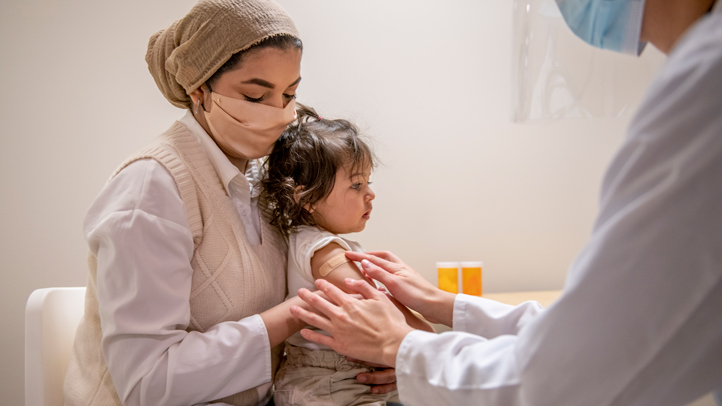 pcv vaccine, mom holding baby at doctor's office