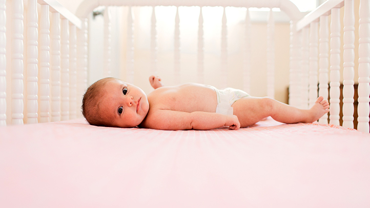 Sleep training your baby, baby wide awake on crib