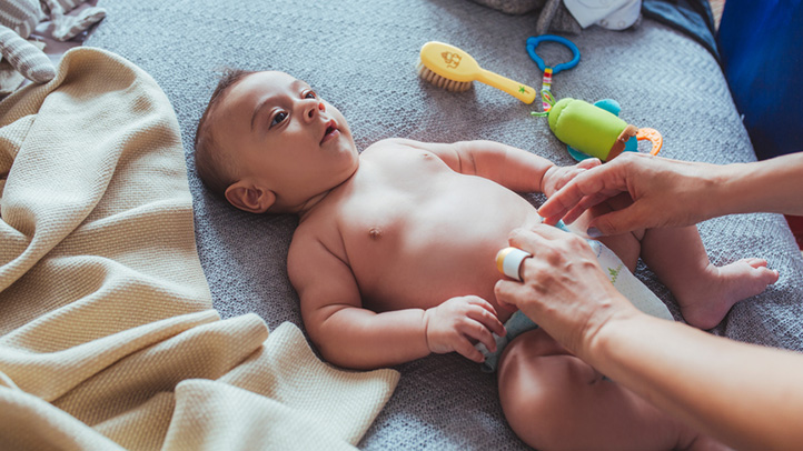 changing a baby's poopy diaper