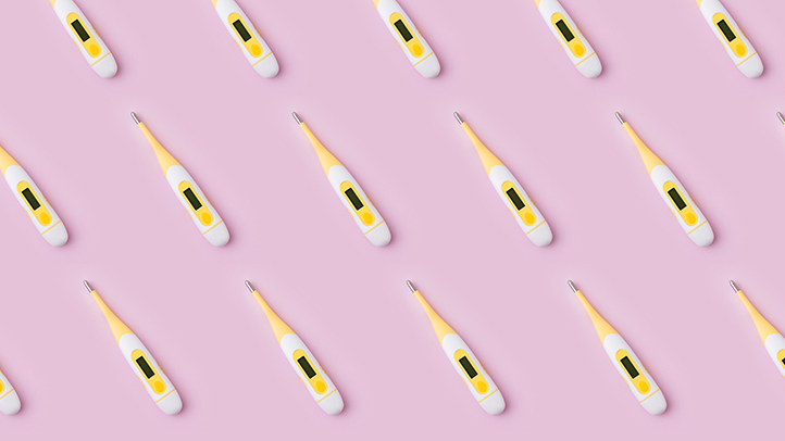 fever in babies and toddlers, thermometers on pink background