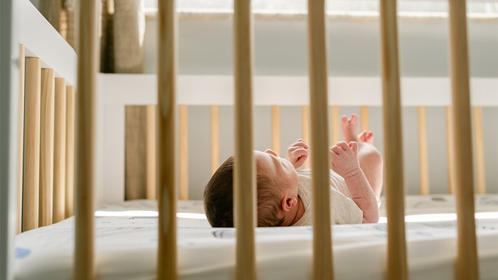 wake windows for baby sleep, baby in crib with sunlight streaming through window