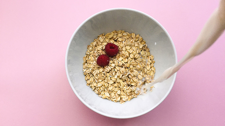 foods to boost breast milk supply, bowl of oatmeal with milk being poured in
