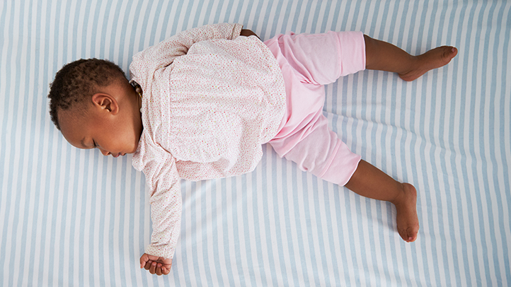 when can baby sleep with a blanket, baby girl with no blanket in crib